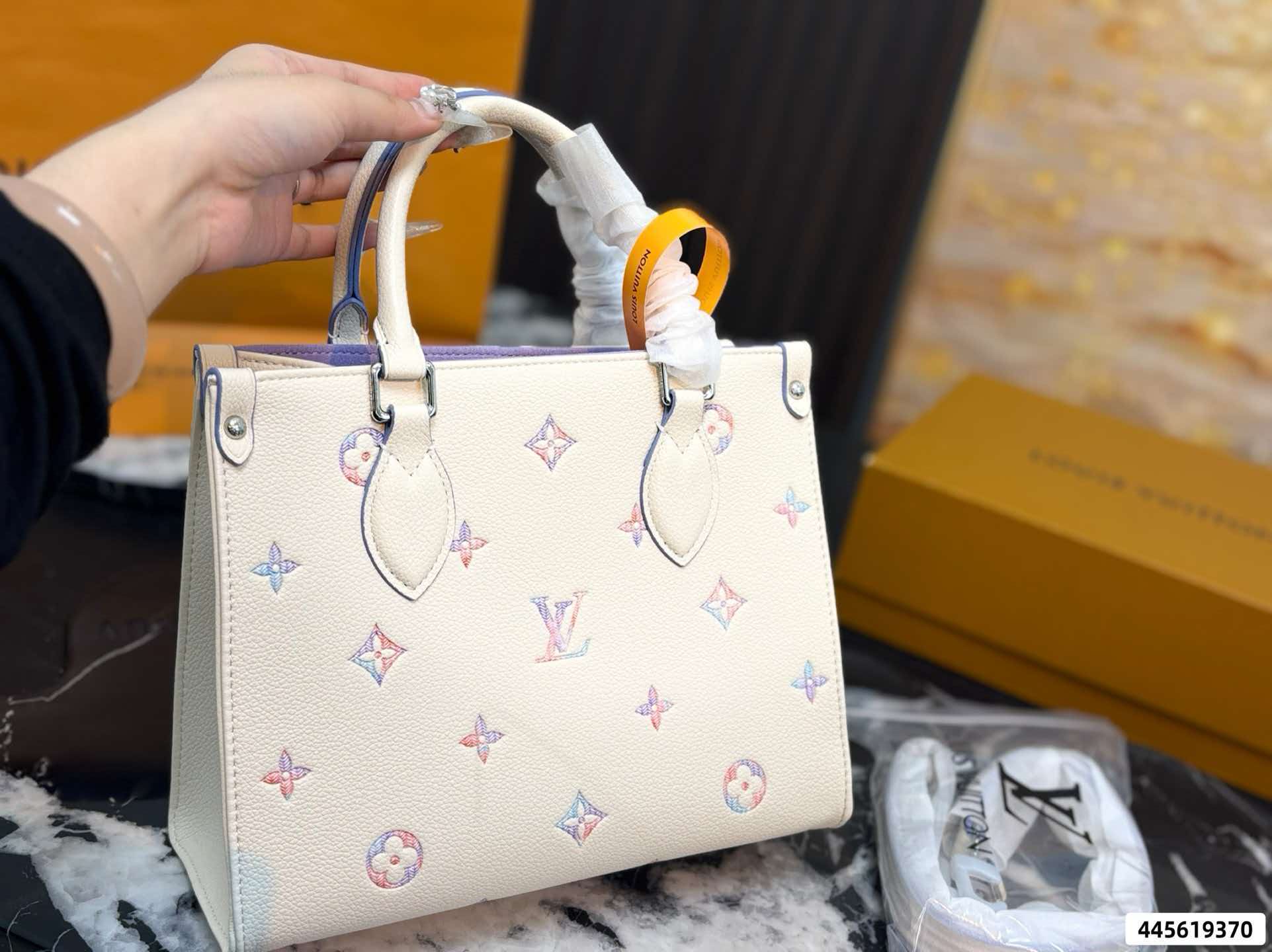 LV On‑The‑Go PM Cream Pink Empreinte Leather Tote Bag
