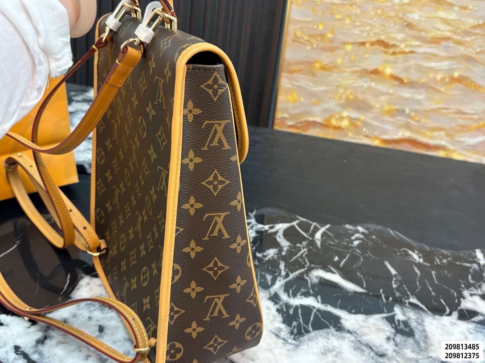 Monogram brown LV Diane Backpack PM, polished gold‑toned hardware with adjustable removable straps